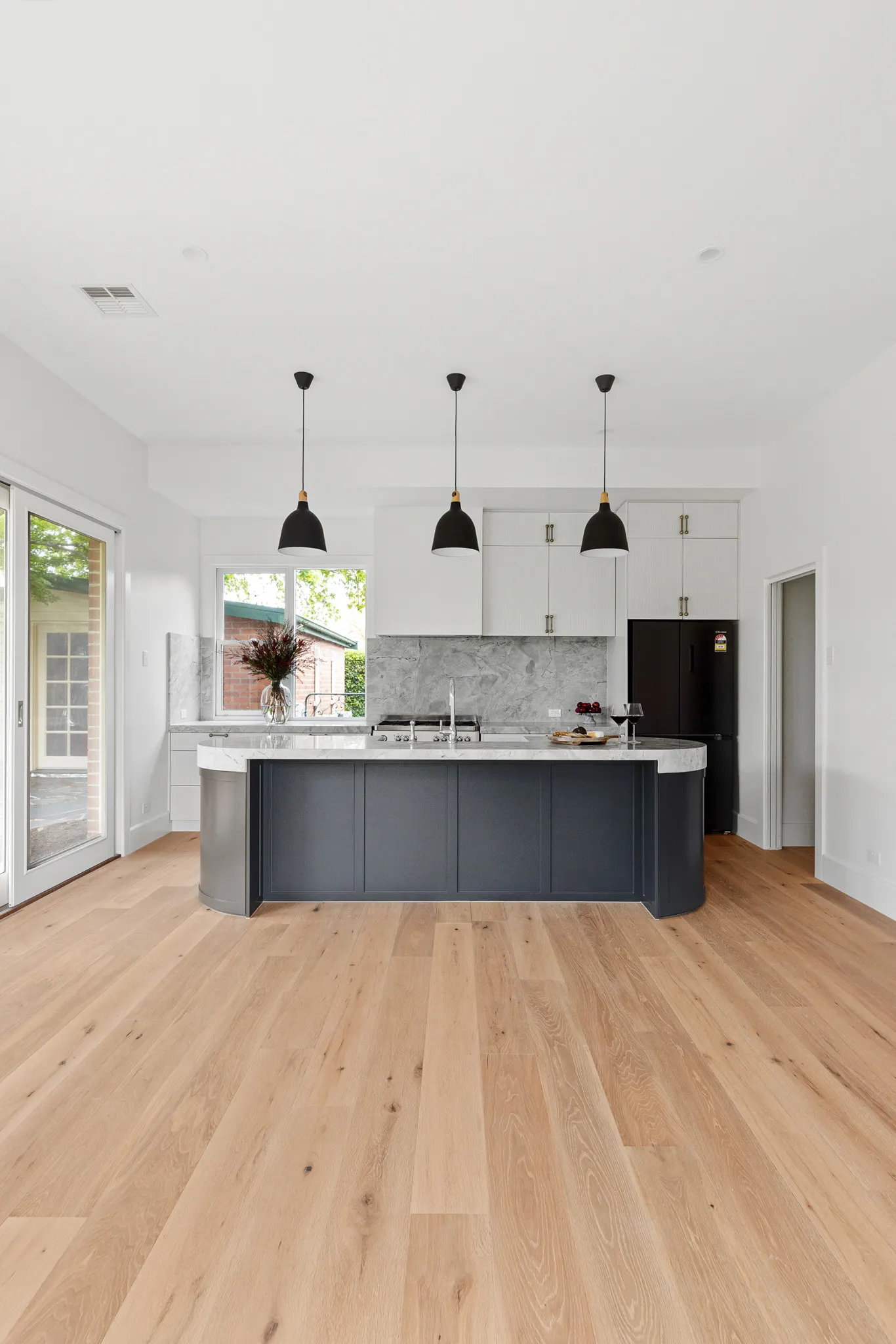 Kitchen at the Barton St home, Kyneton, with a navy island and marble benchtop