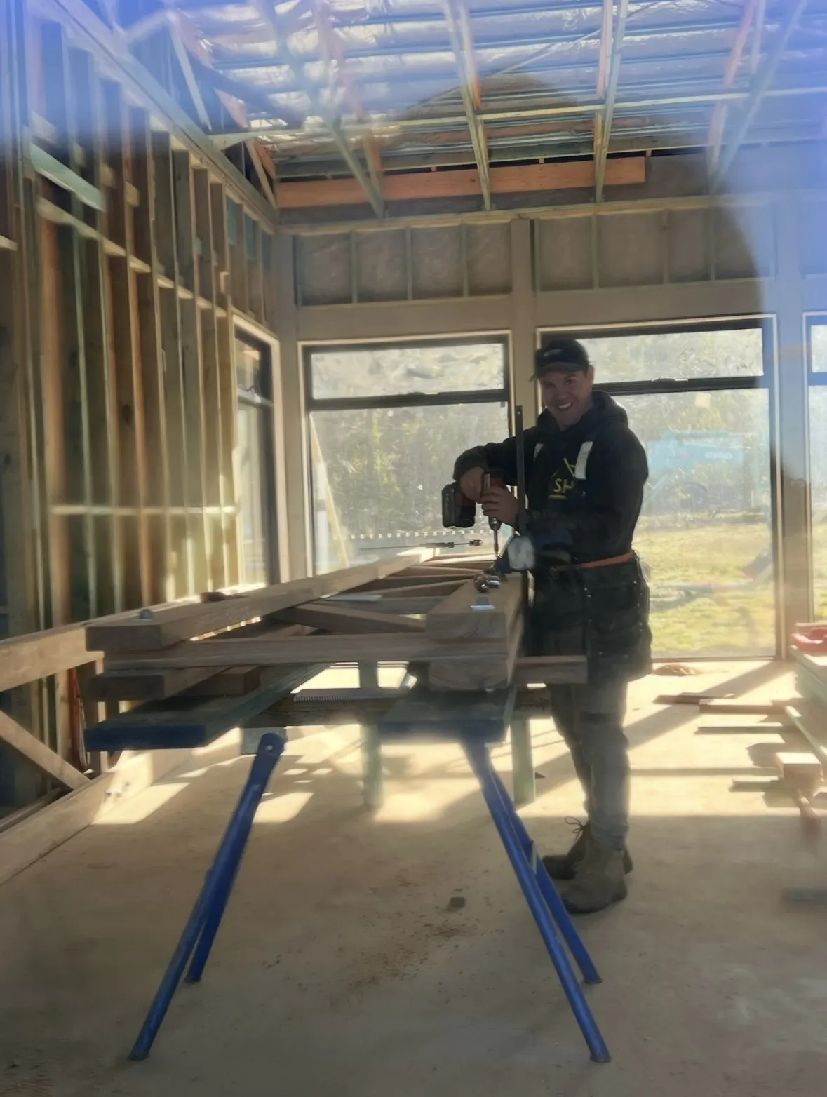 A Summerfield Homes carpenter assembling a timber truss on site