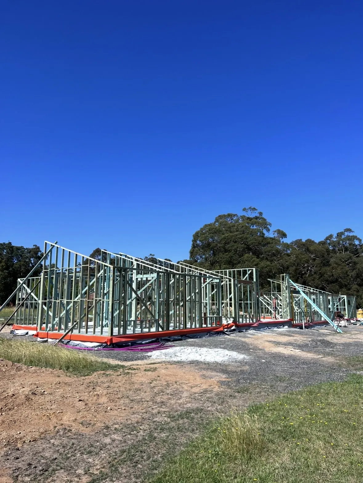 Wall frames standing on the slab of a Summerfield Homes custom home