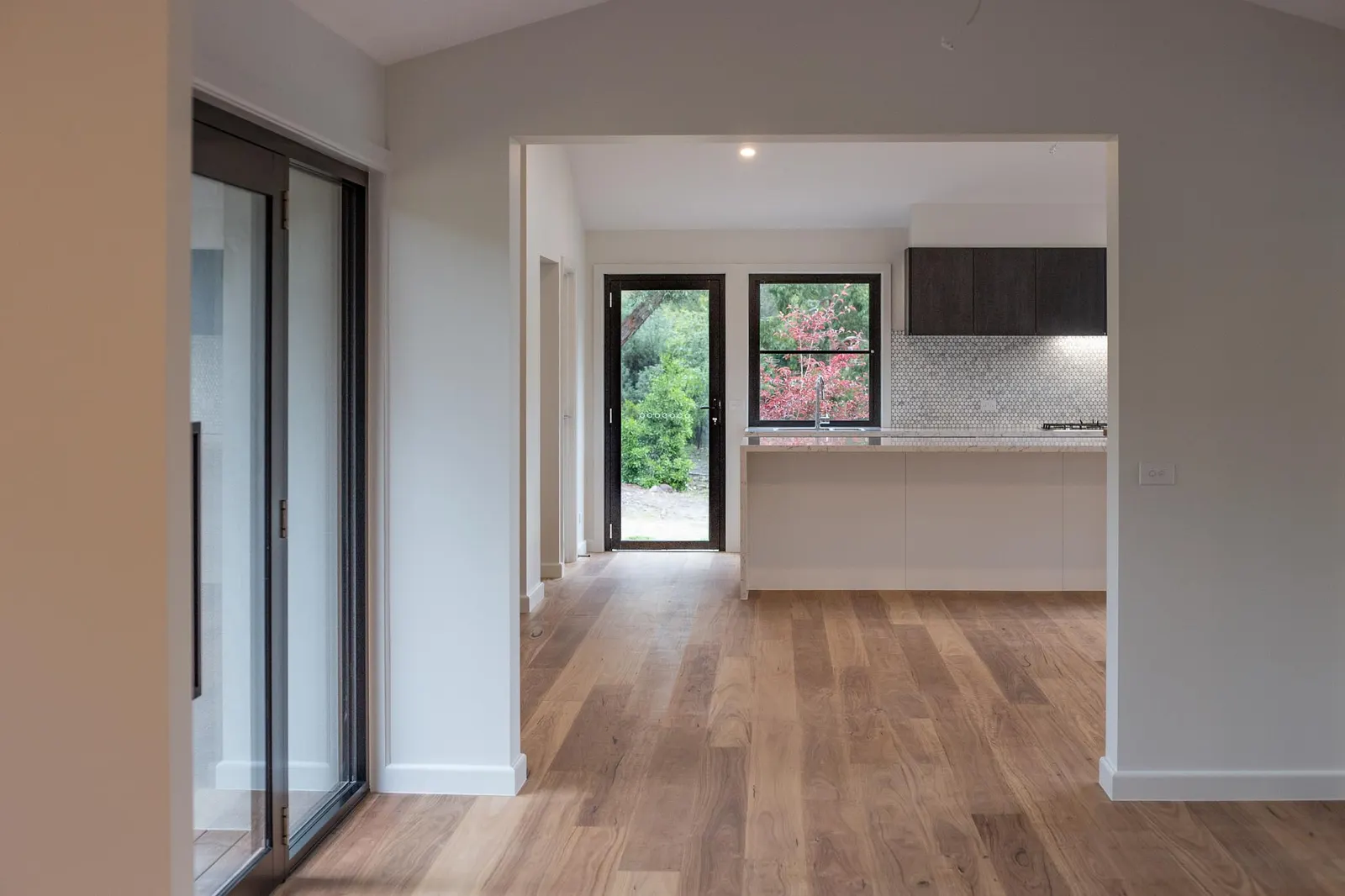 Oak floors leading from the living area through to the kitchen and rear entry door