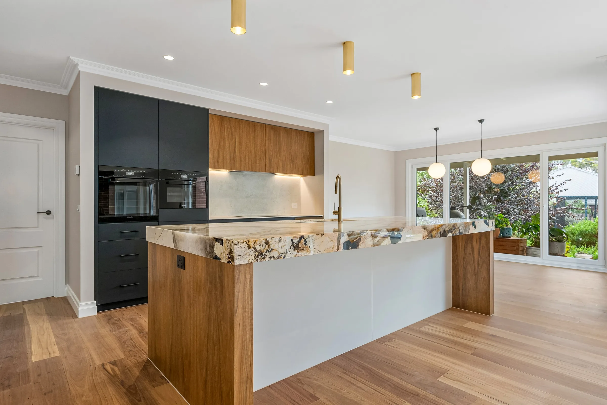 Domain Mews kitchen in Gisborne with a figured stone island and timber joinery