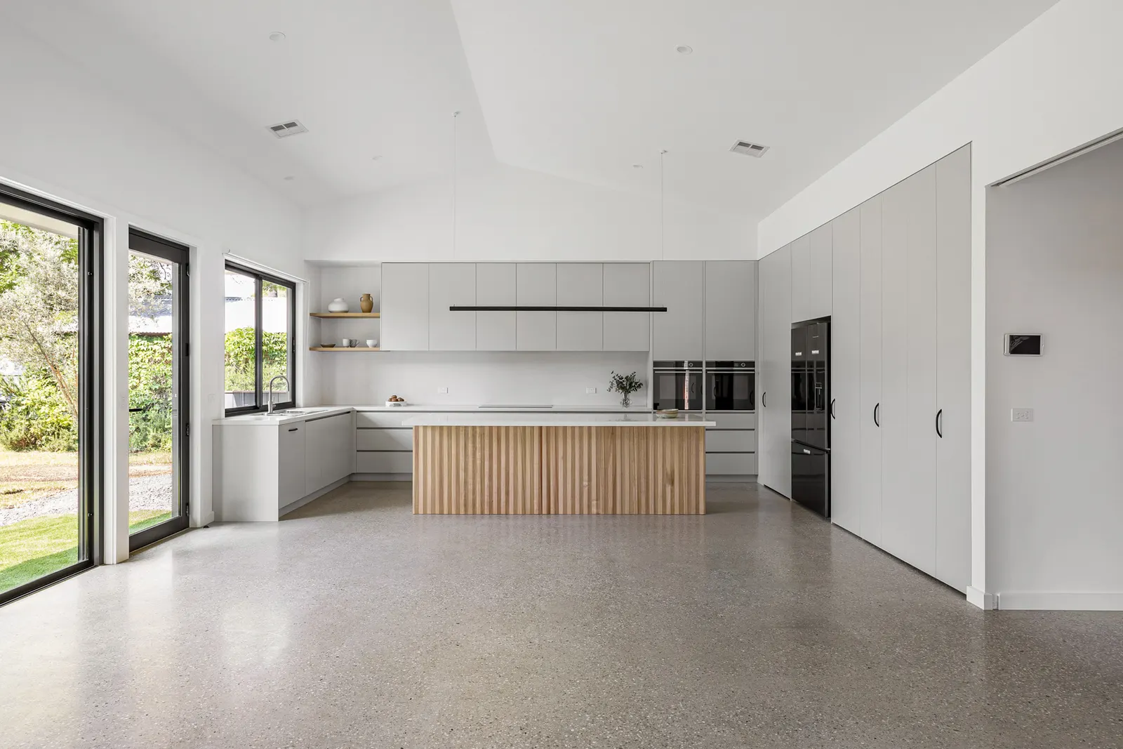 Open-plan living looking through to the kitchen, sliding doors opening to the garden