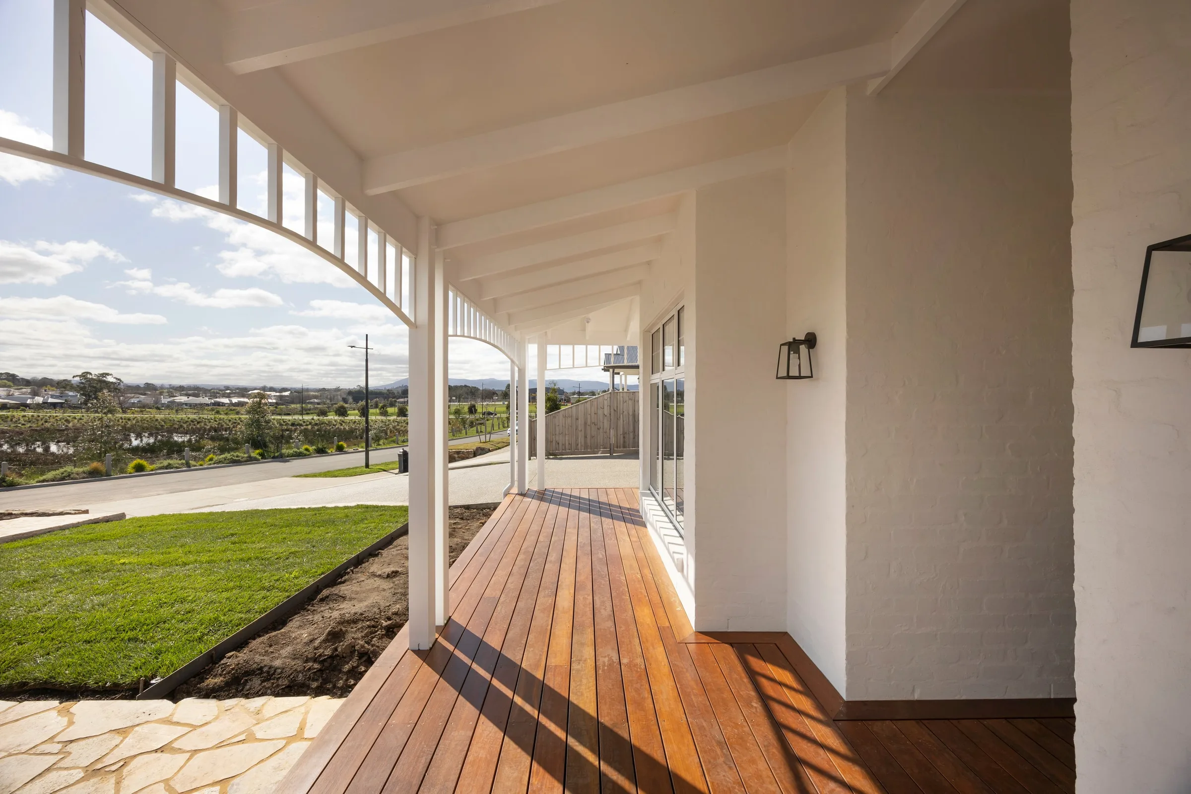 Verandah corner opening onto the lawn, with the hills in the distance