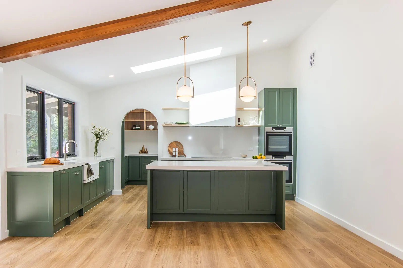 Green island and rangehood canopy under the raked ceiling of the Spencer Rd kitchen