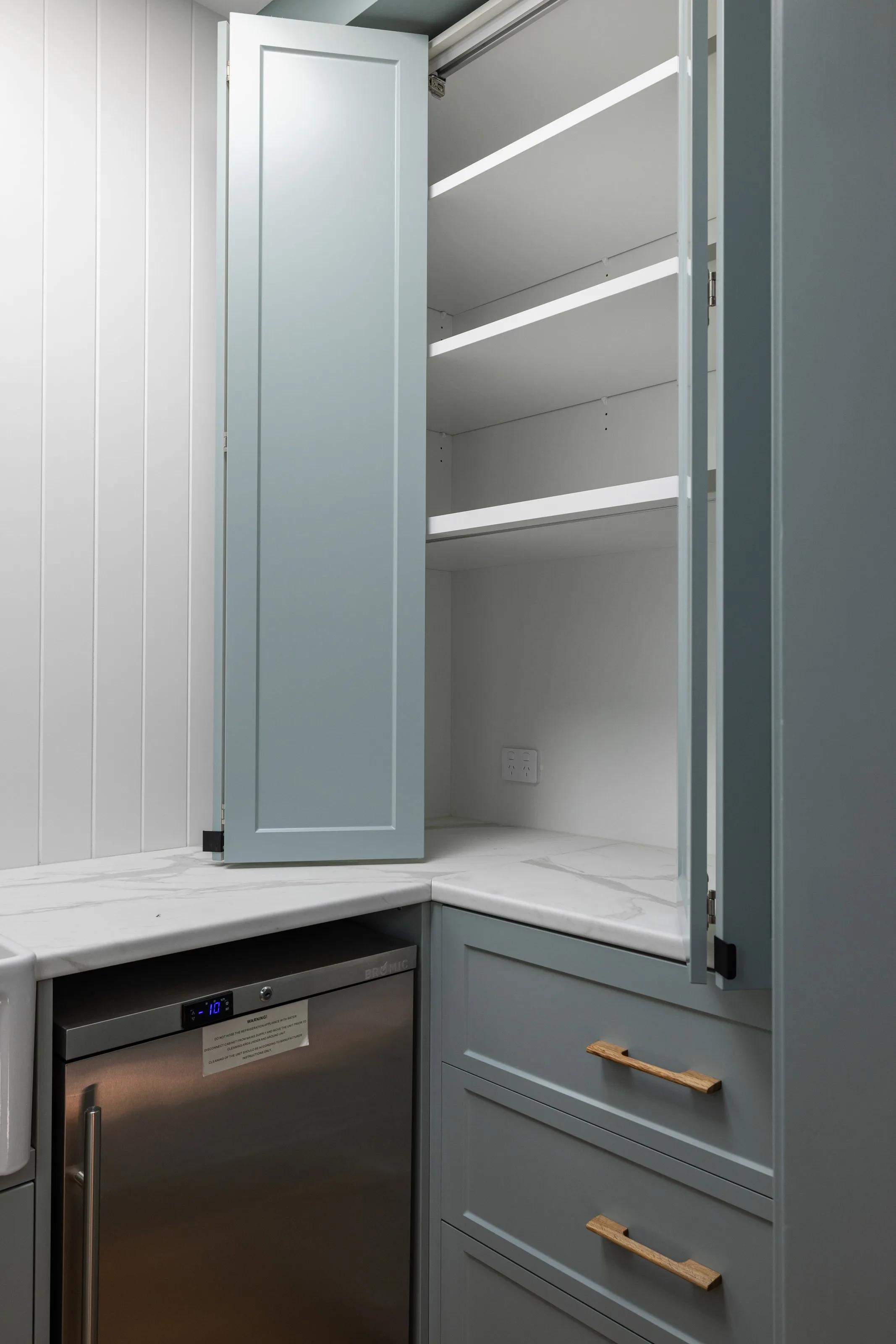 Butler&rsquo;s pantry corner with open shelving, stone benchtop and timber pull handles