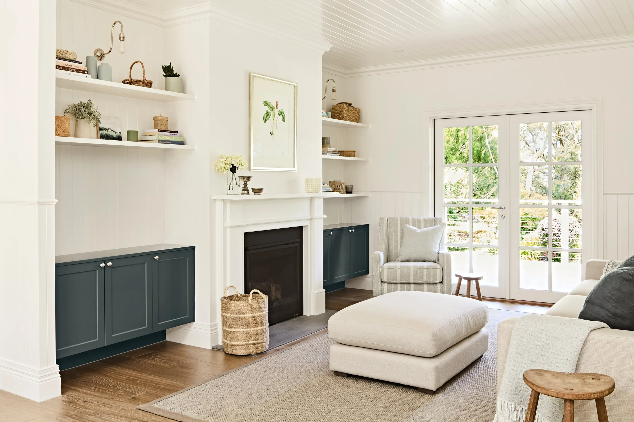 Linen ottoman on a jute rug beside French doors opening to the garden