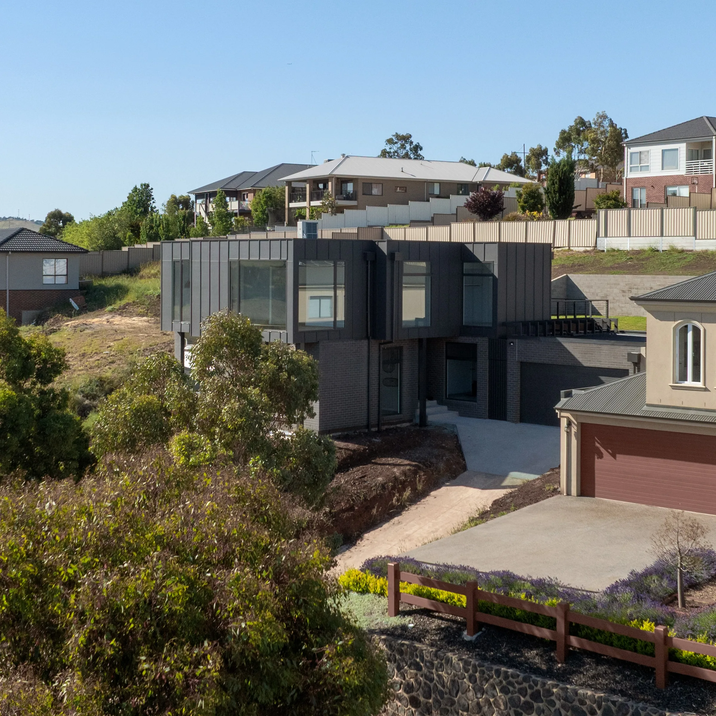 Elevated view of Westminster by Summerfield Homes, dark cladding on a sloping site