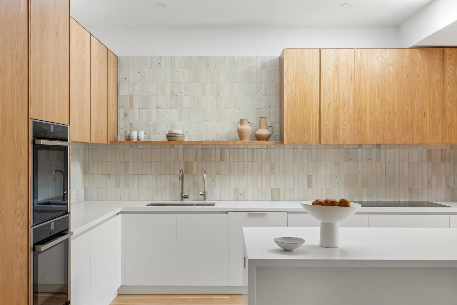 Oak overhead joinery and a handmade-look tiled splashback above white base joinery